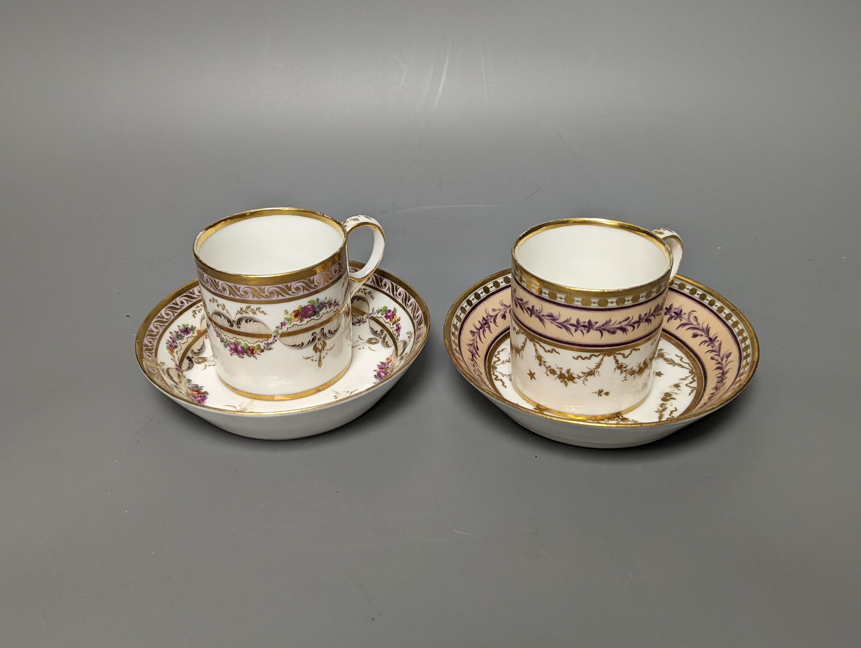 A Duc d'Angouleme coffee can and saucer painted with a puce chain of leaves on a salmon coloured ground and another painted with a flower chain, black feather and a gilt line, latter with stencilled red mark 'Manuf de M